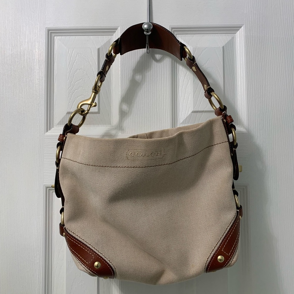 Coach canvas bag with leather trim and handles.